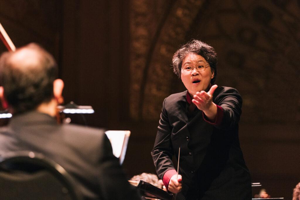 c41623e05fd75689015a20f5ea6b9f7f4b8a16db Mei-Ann Chen conducting the orchestra