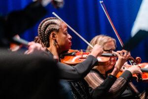 A woman playing violin.