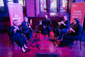 Four musicians playing their instruments.