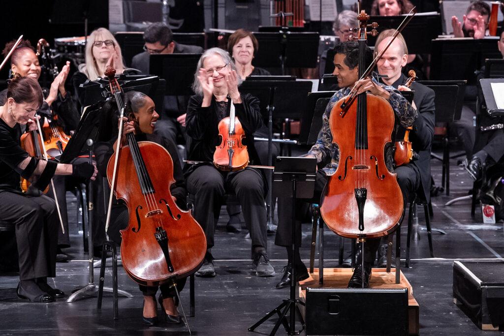 An image of two cellists playing together.